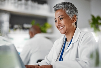 Woman smiling while working at a lab