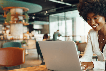 Young woman on laptop at coffee shop