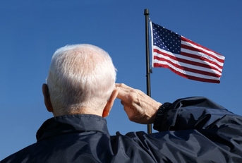 Veteran saluting the American flag