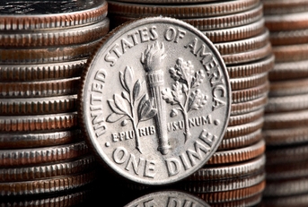 Pilo of old coins and dime coin highlighted 