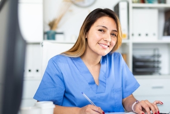Female physician assistant working at desk