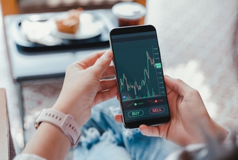 Woman looking at an investing app on her phone