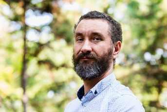 Man in his early 50s looking at camera