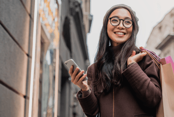 person with shopping bags and phone
