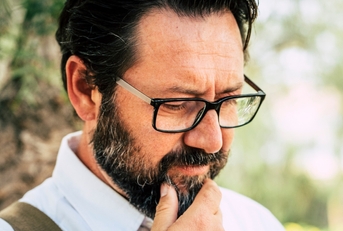 Man in his 50s thinking 