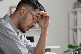 Man looking stressed at computer