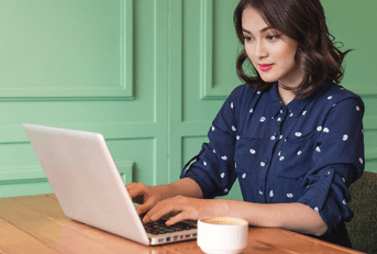 Woman on computer at coffee shop