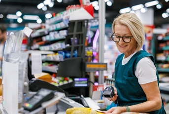 Senior woman working as a cashier 