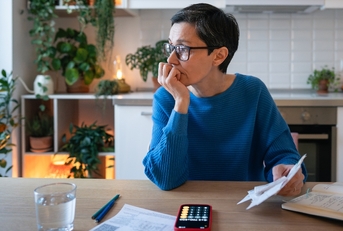 Woman looking worried about debt and bills