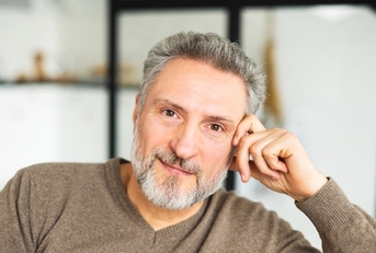 Man in his mid 60s looking at camera