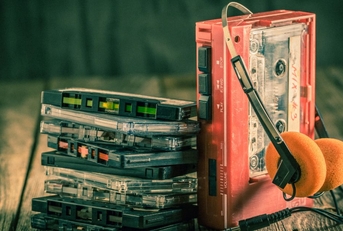 Walkman with headphones and cassette tapes