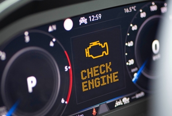 Car dashboard with engine light on