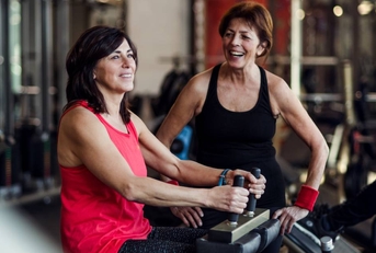 Two senior women working out at the gym