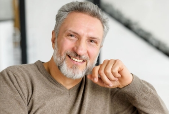 Portrait of a mature man in a brown sweater
