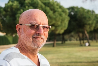 portrait of 65-year-old man in a park 