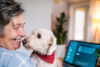 Senior with her dog and laptop