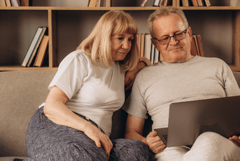 Couple using laptop at home