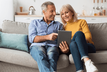 Middle-aged couple sitting on couch