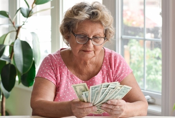 Older woman counting cash