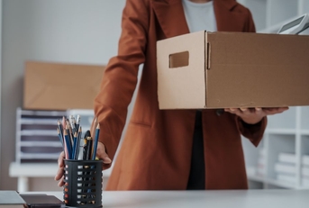 Woman cleaning her desk, leaving her job