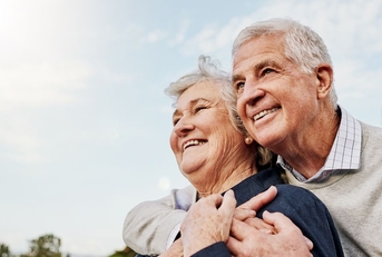 Happy elderly couple hugging