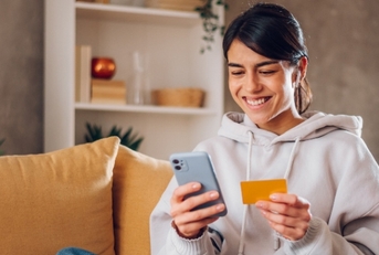 Woman using credit card on cell phone 2