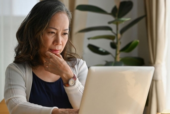 Older woman at home on laptop