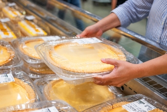 Woman grabbing Costco pie