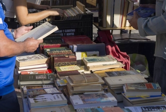 People looking for a book in a vintage market