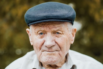Portrait of an elderly man wearing a cap