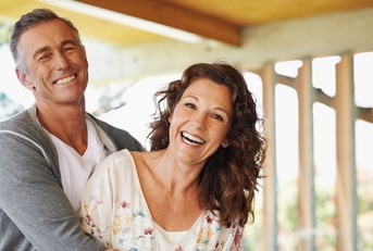 Hugging, smiling couple in their 50s