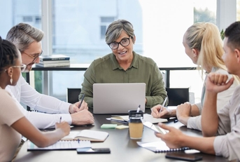 Mature business woman leading meeting