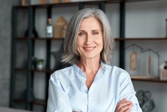 Mature woman smiling with arms crossed