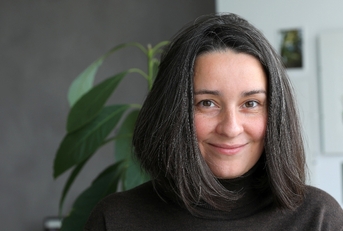 Woman in her 40s smiling at camera