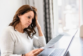 Concerned mature woman looking at paper