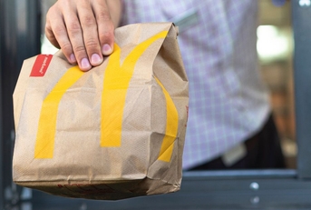 McDonald's bag being handed through the drive thru window