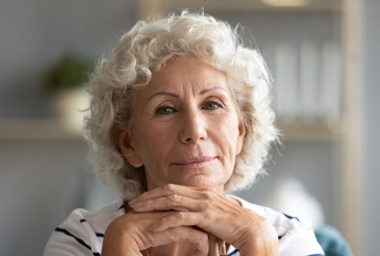 Portrait of a senior woman with her hands under her chin