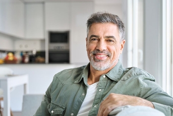 Smiling mature man in a green shirt