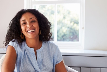 Smiling woman in her 40s with a blue top