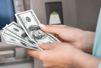Woman getting money out of atm