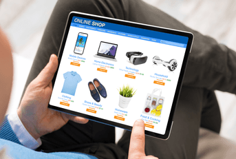 Man online shopping on tablet at home
