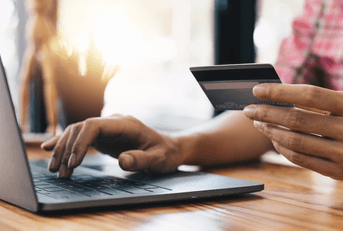 Person online shopping using rewards credit card