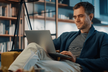 Young man looking at online banking on laptop