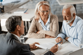 Financial advisor sitting with older couple