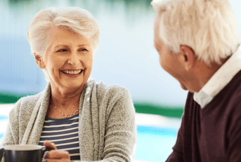 Older couple enjoying breakfast on their patio