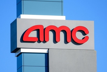 AMC sign, logo advertises AMC movie theater on a sunny day under blue sky 