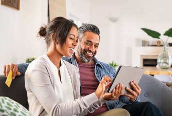 Couple on couch with tablet