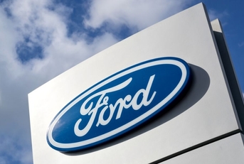 Ford dealership sign against blue sky
