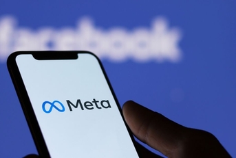Meta logo on smartphone screen and Facebook logo background