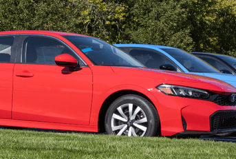 Honda civics in line at dealership outside